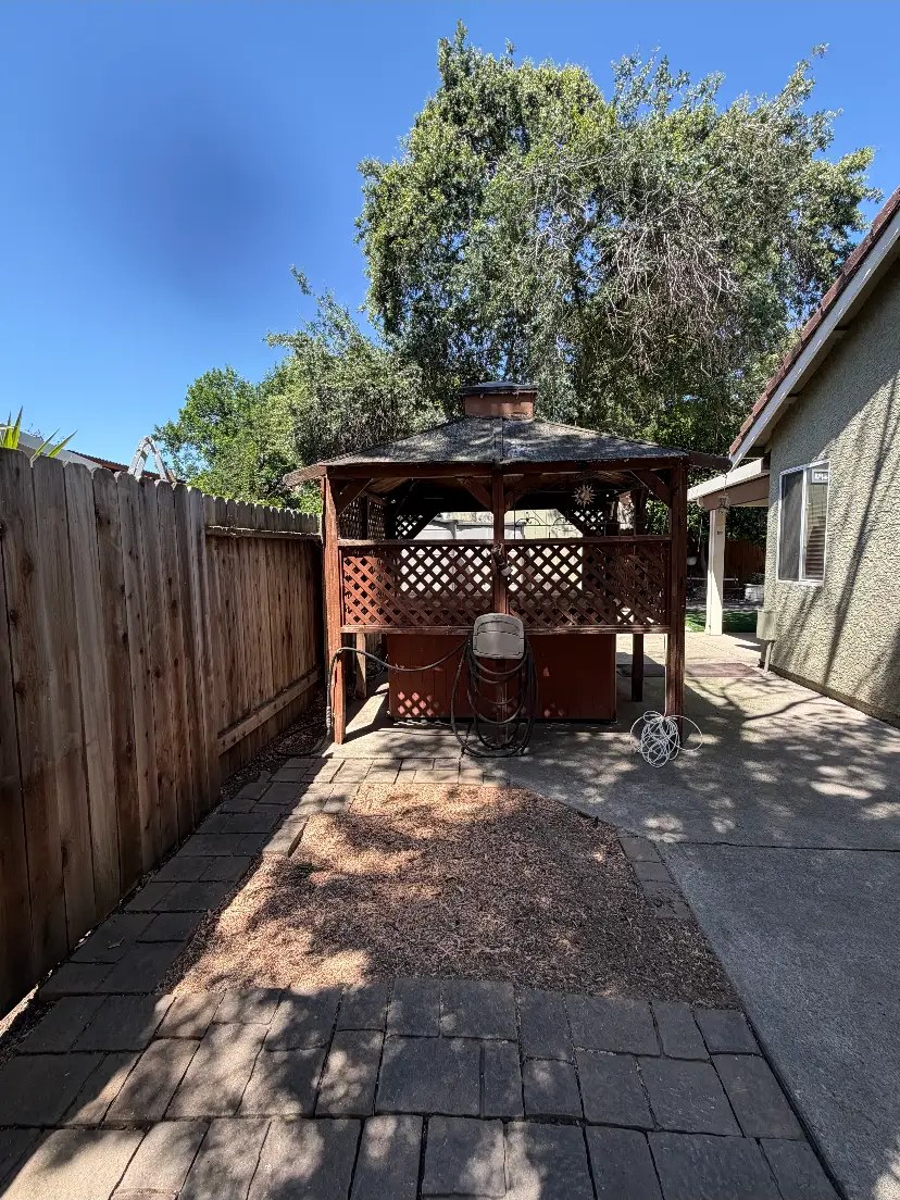 Backyard tree removed over a gazebo — after Timberland Tree Service